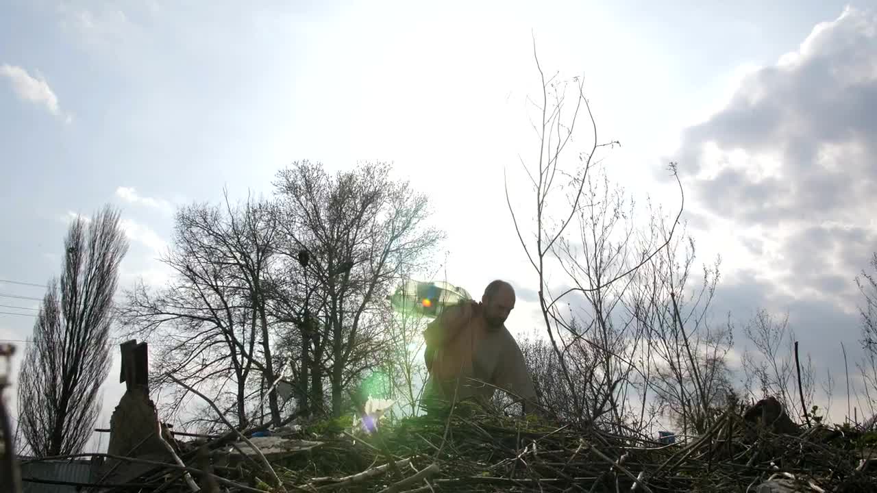 Stock Video Homeless Man Climbing Over Garbage Animated Wallpaper