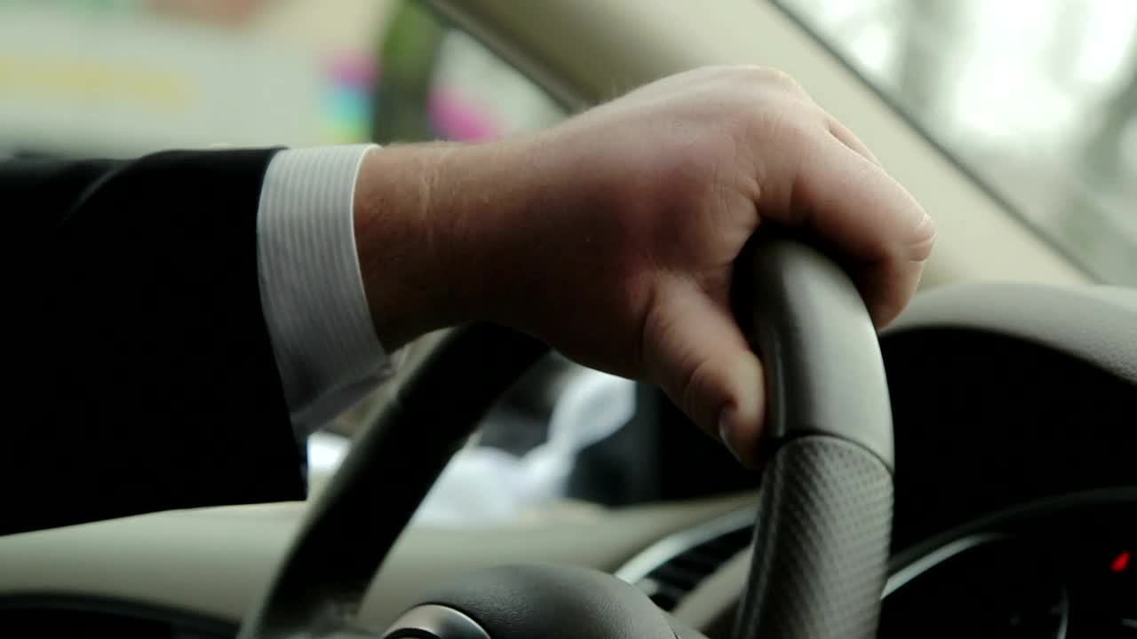 Stock Video Holding The Steering Wheel Of A Car While Driving Animated Wallpaper