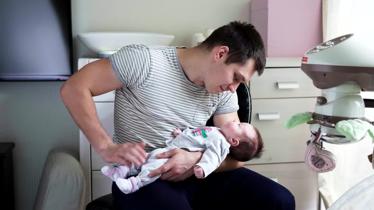 Stock Video Holding His Newborn Child In His Arms Animated Wallpaper