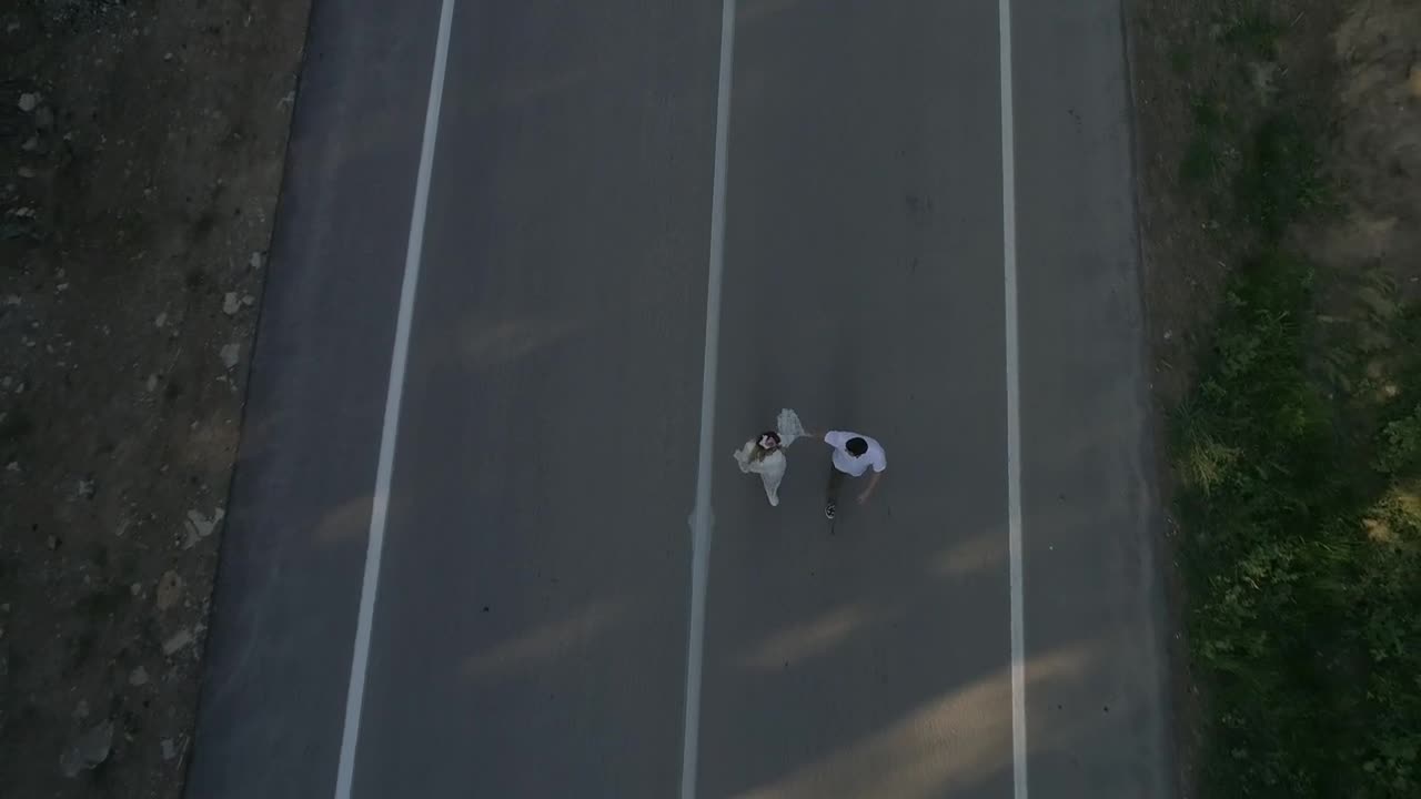 Stock Video Holding Hands While Walking Down A Road Animated Wallpaper