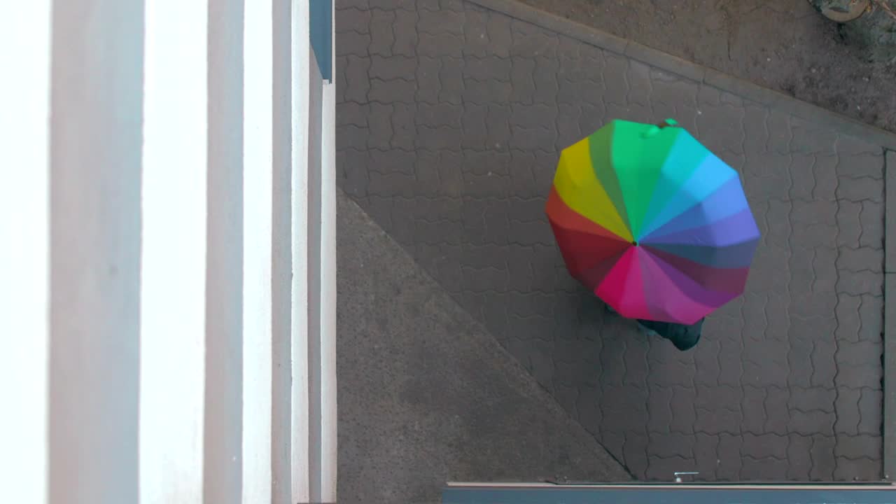 Stock Video Holding A Rainbow Umbrella Outside Animated Wallpaper