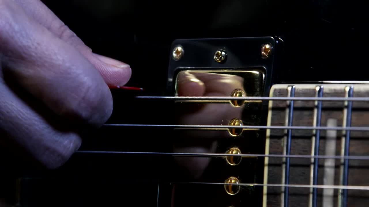 Stock Video Holding A Guitar Pick Animated Wallpaper