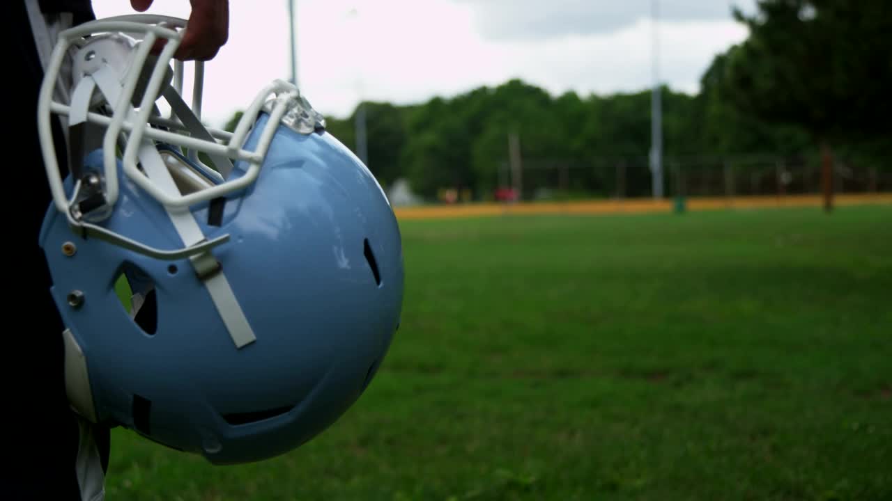 Stock Video Holding A Football Helmet At A Court Animated Wallpaper