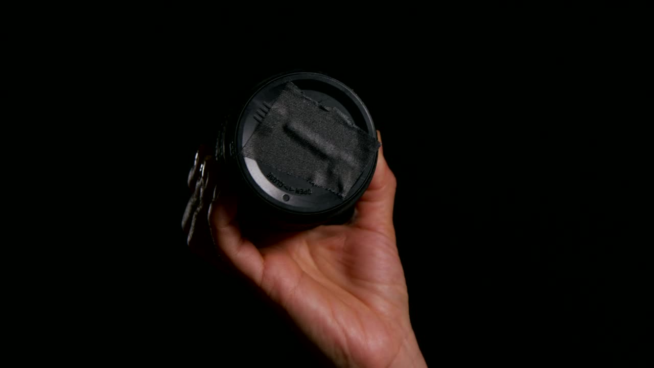 Stock Video Holding A Camera Lens Cap Animated Wallpaper