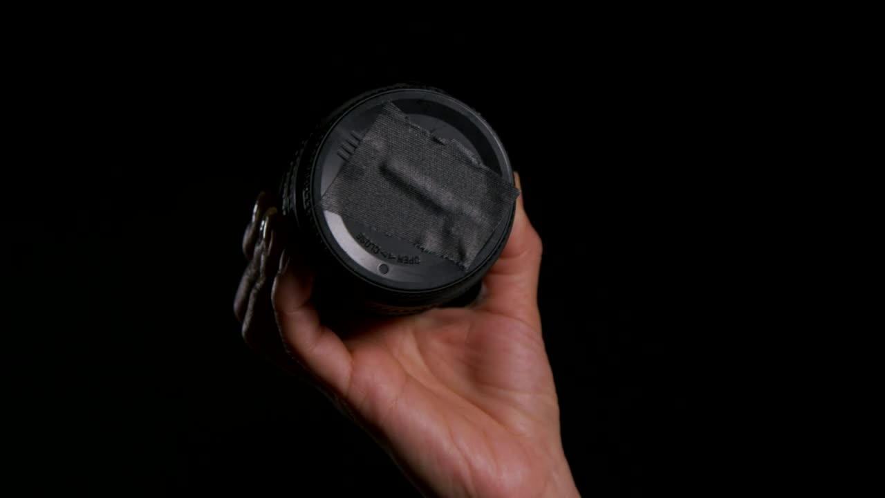 Stock Video Holding A Camera Lens Animated Wallpaper