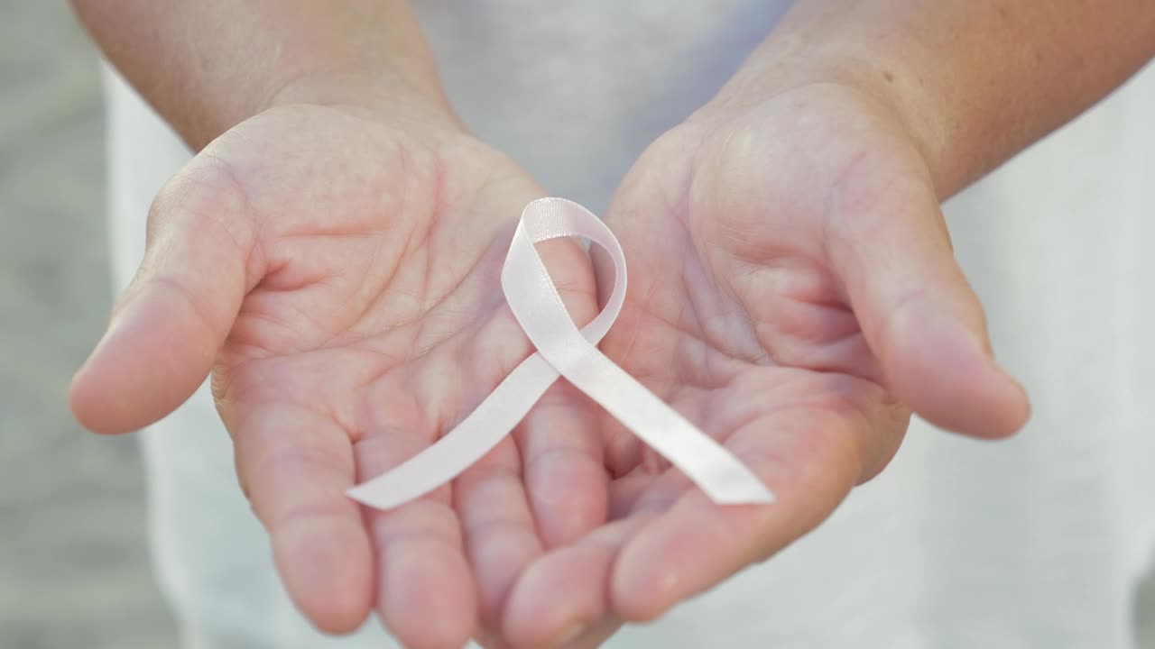 Stock Video Holding A Breast Cancer Ribbon In Her Hands Animated Wallpaper