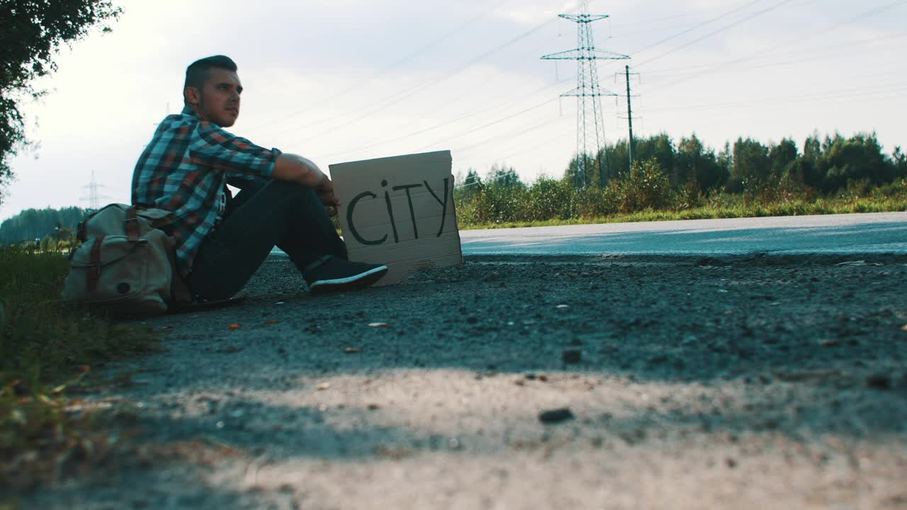 Stock Video Hitchhiker With A Cardboard Sign Animated Wallpaper