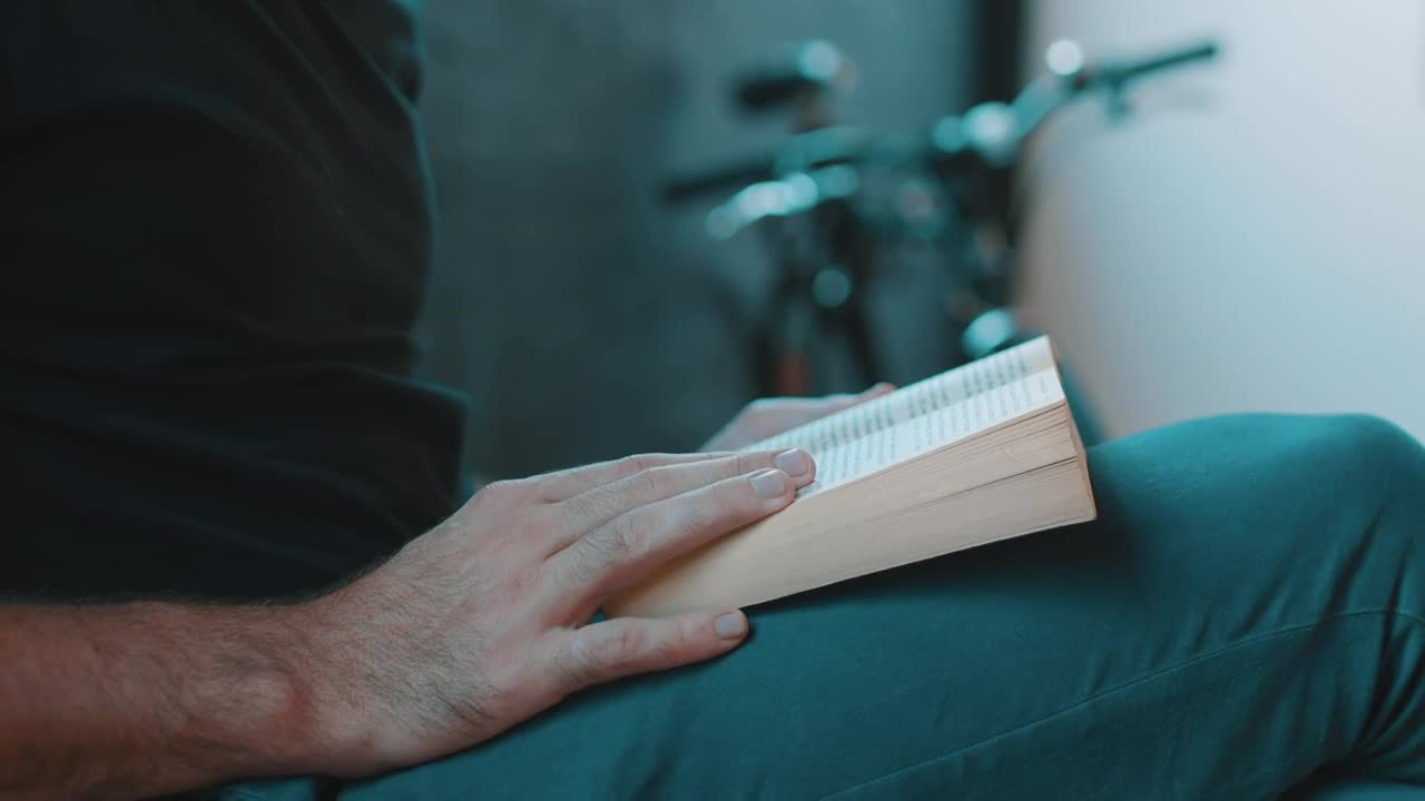 Stock Video Hipster Reading A Book Next To A Bicycle Animated Wallpaper