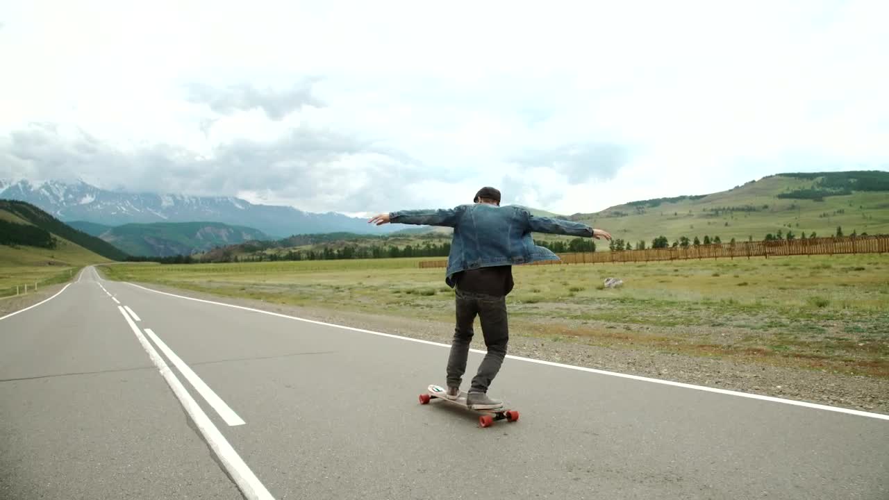 Stock Video Hipster Man On A Longboard On The Road Animated Wallpaper