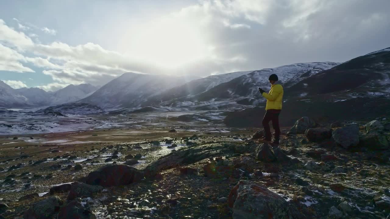 Stock Video Hiker Taking Photos At The Mountains Animated Wallpaper