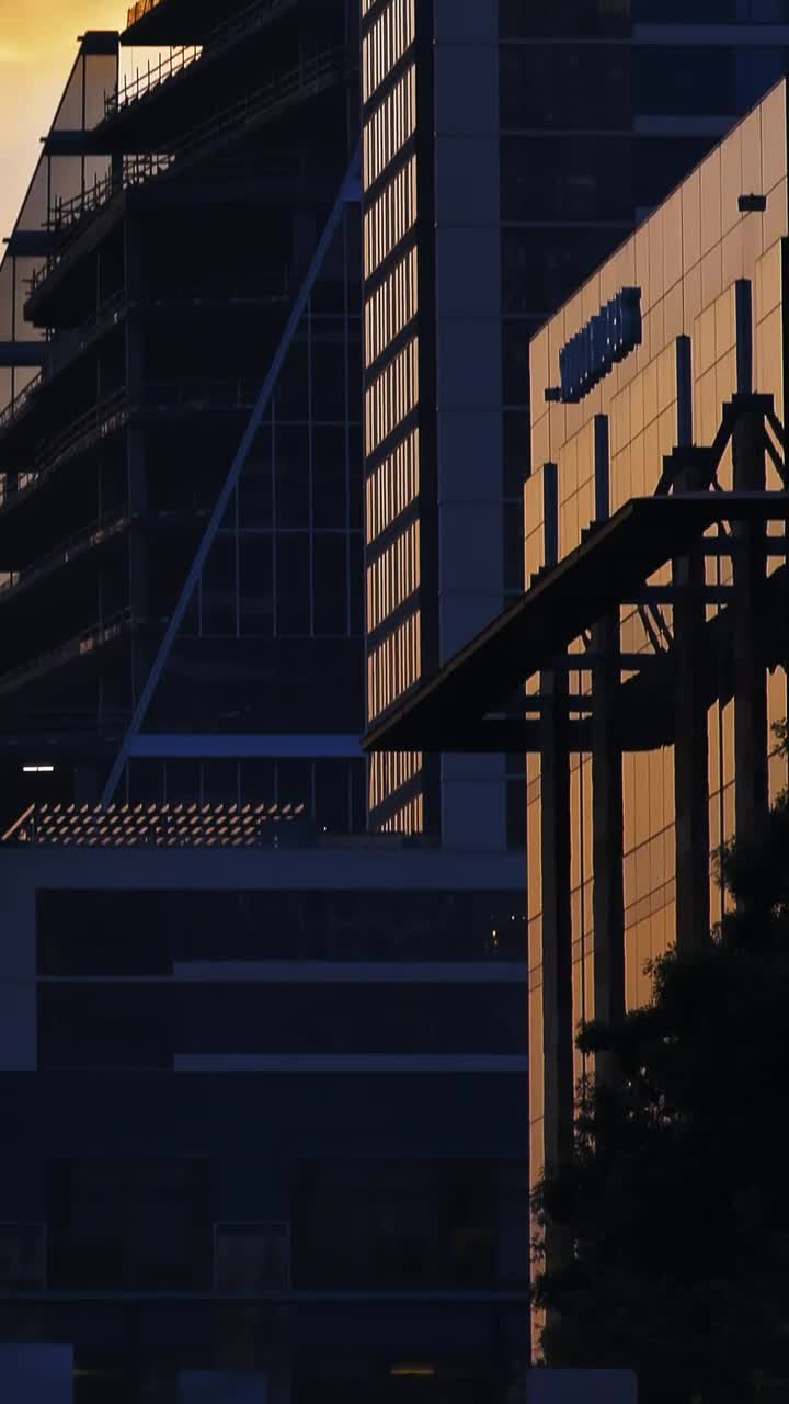 Stock Video High Skyscrapers Of A City During Sunset Animated Wallpaper