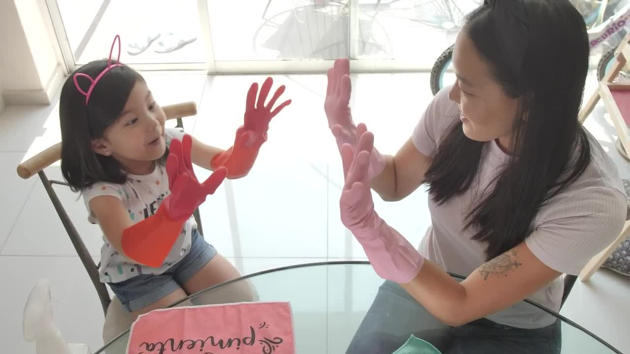 Stock Video Hi Five Between Mother And Daughter For Cleaning Their House Animated Wallpaper