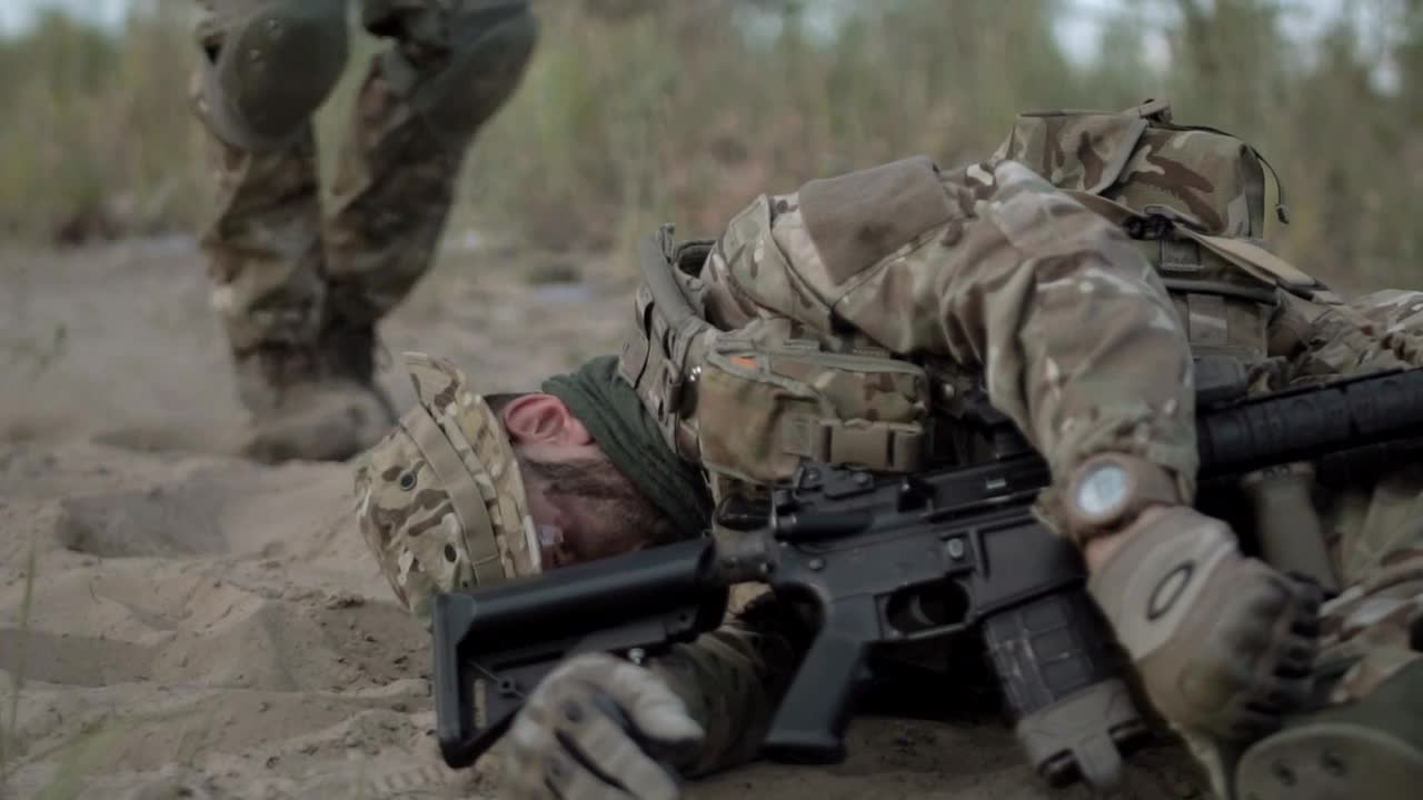 Stock Video Helping A Wounded Soldier In The Battlefield Animated Wallpaper