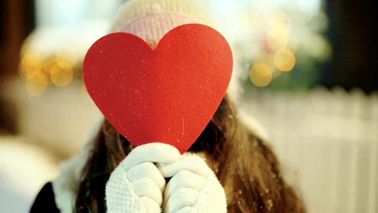 Stock Video Heart Cutout Reveals Smiling Young Woman In Winter Scene Animated Wallpaper