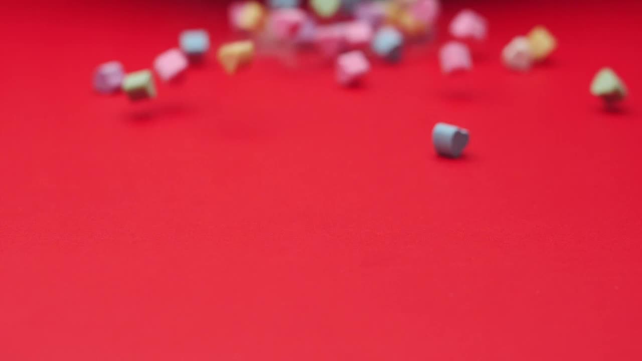 Stock Video Heart Candies Sliding On A Red Surface Animated Wallpaper