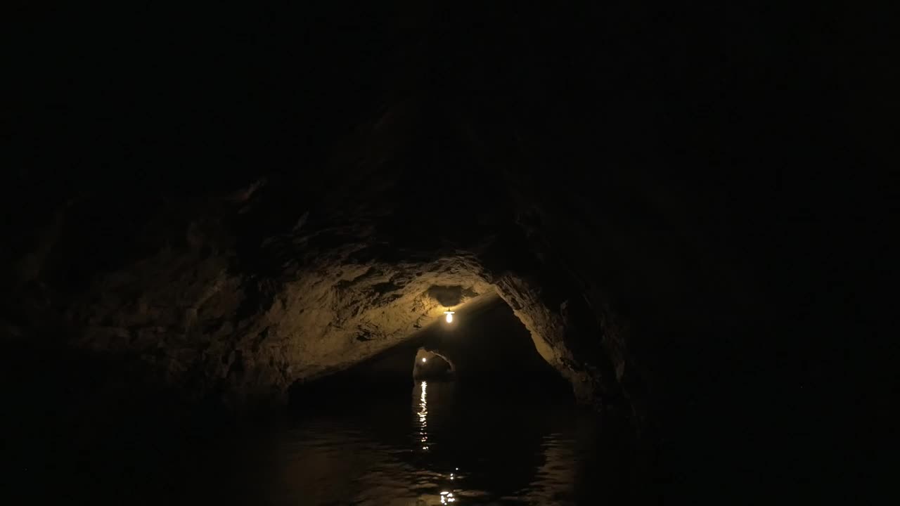 Stock Video Heading Through A Dark Cave By Boat Animated Wallpaper