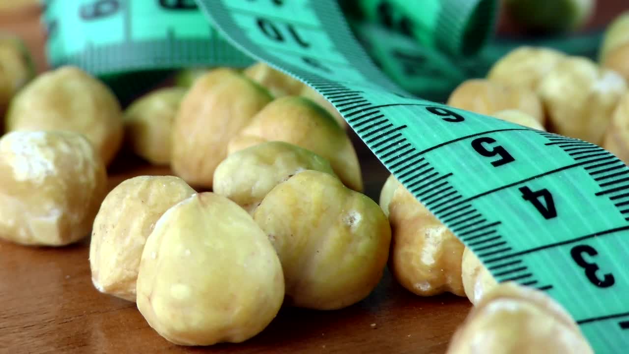 Stock Video Hazelnuts And Measuring Tape Macro Animated Wallpaper