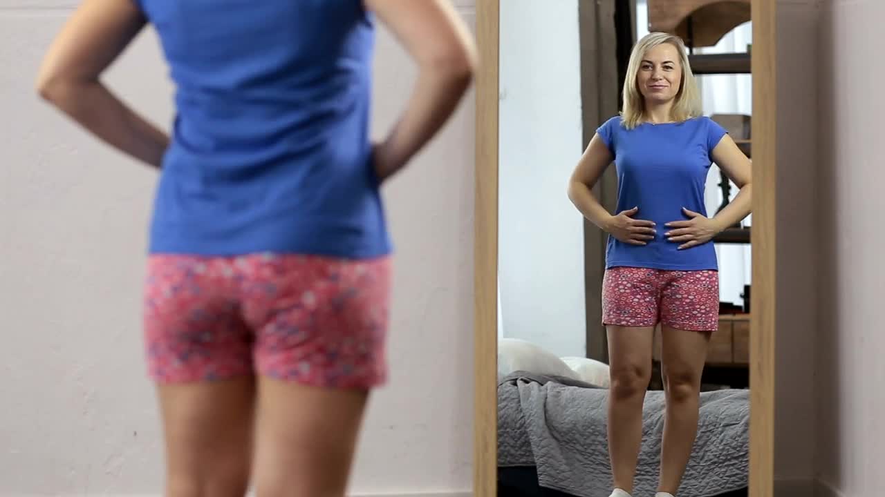 Stock Video Happy Woman While She Looks In The Mirror Animated Wallpaper