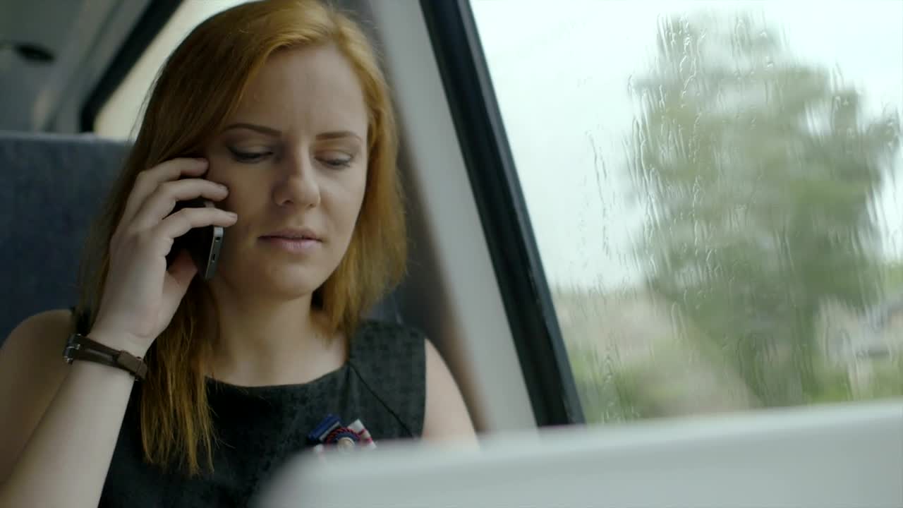 Stock Video Happy Woman Talking On The Phone Inside A Vehicle Animated Wallpaper