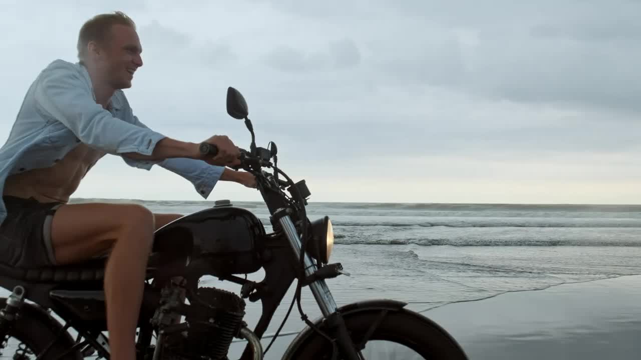 Stock Video Happy Wanderlust Riding A Motorcycle At The Beach Animated Wallpaper