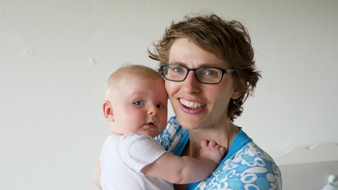 Stock Video Happy Mother Holds And Kisse Baby On White Background Animated Wallpaper