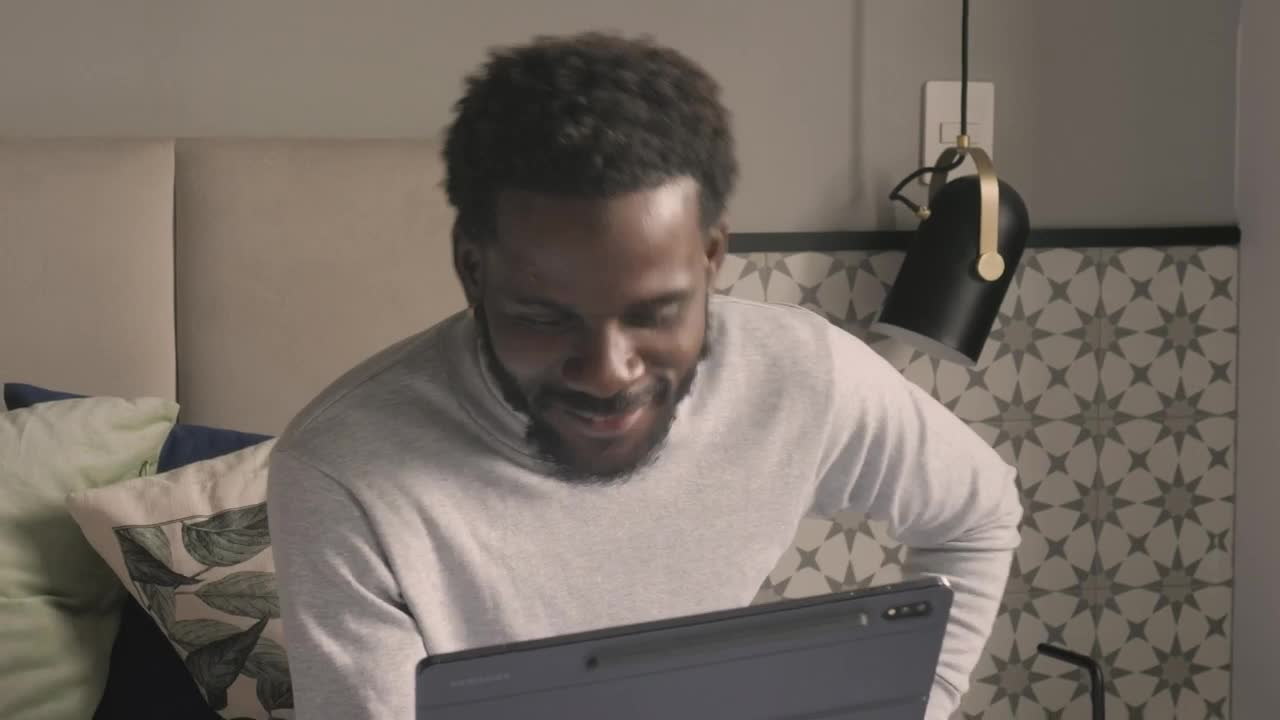 Stock Video Happy Man Chatting By Video Call On A Tablet Animated Wallpaper