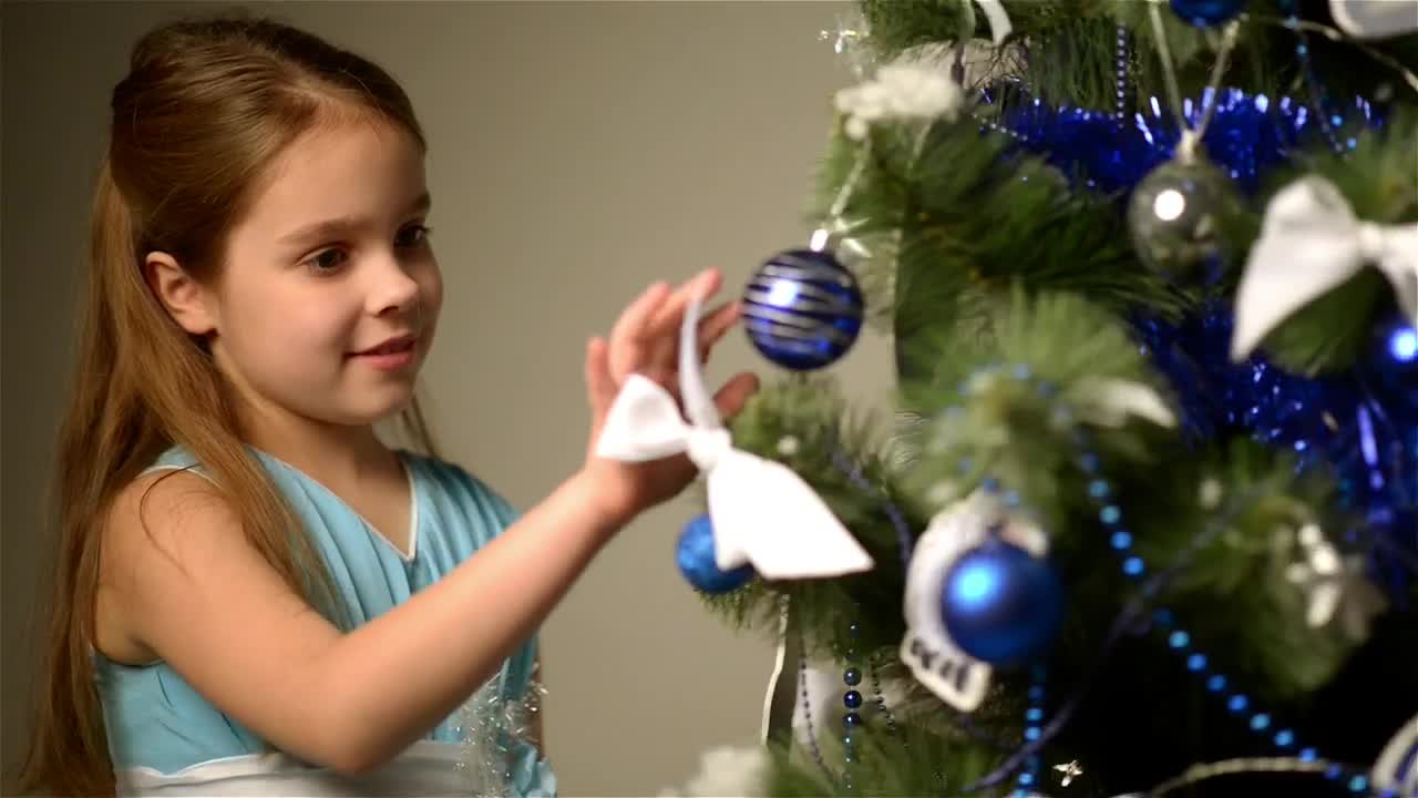 Stock Video Happy Little Girl Next To A Christmas Tree Animated Wallpaper