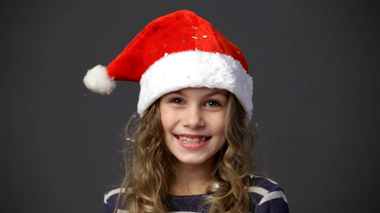 Stock Video Happy Girl Wearing A Christmas Hat Animated Wallpaper