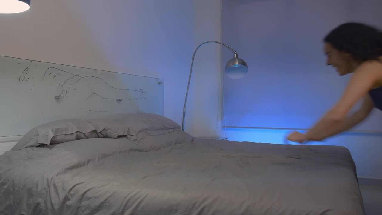 Stock Video Happy Girl Throws Herself On A Bed Animated Wallpaper