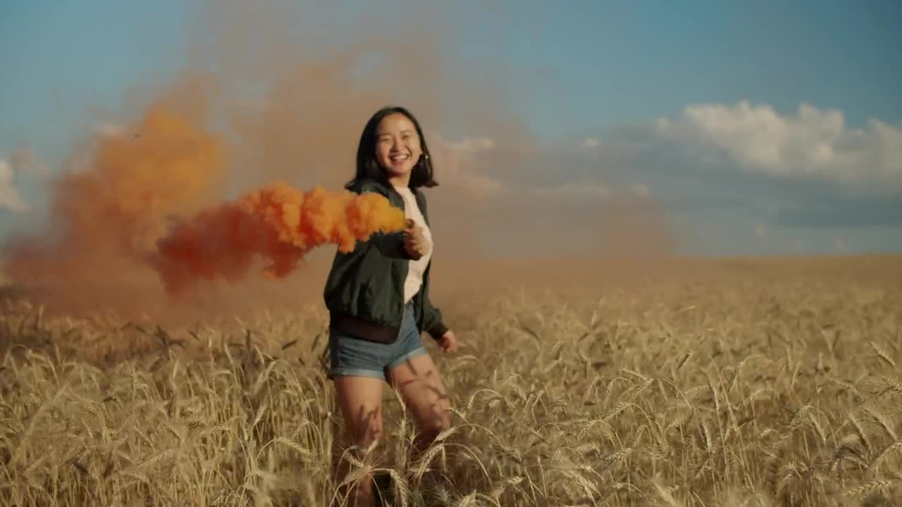 Stock Video Happy Girl Jumping With A Smoke Flare Animated Wallpaper