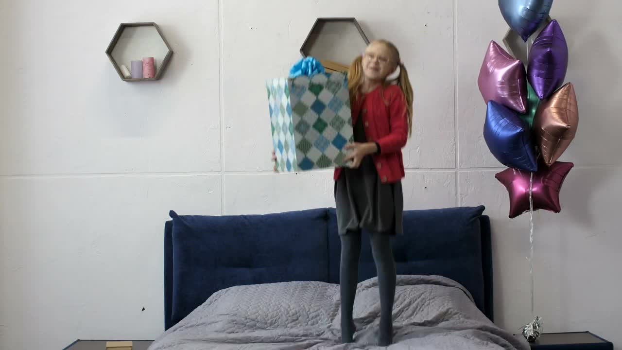 Stock Video Happy Girl Jumping On Her Bed With A Gift Animated Wallpaper