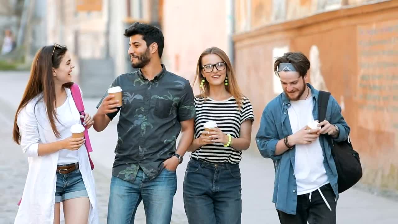 Stock Video Happy Friends Walk Down The Street While Talking Animated Wallpaper