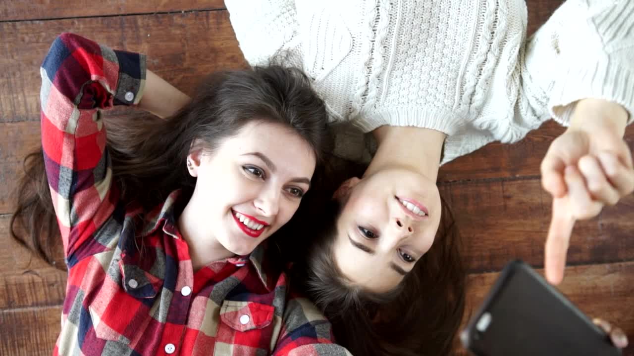 Stock Video Happy Female Friends Taking Selfies On The Floor Animated Wallpaper