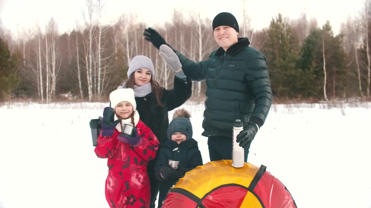 Stock Video Happy Family Waving In A Snowy Forest Animated Wallpaper