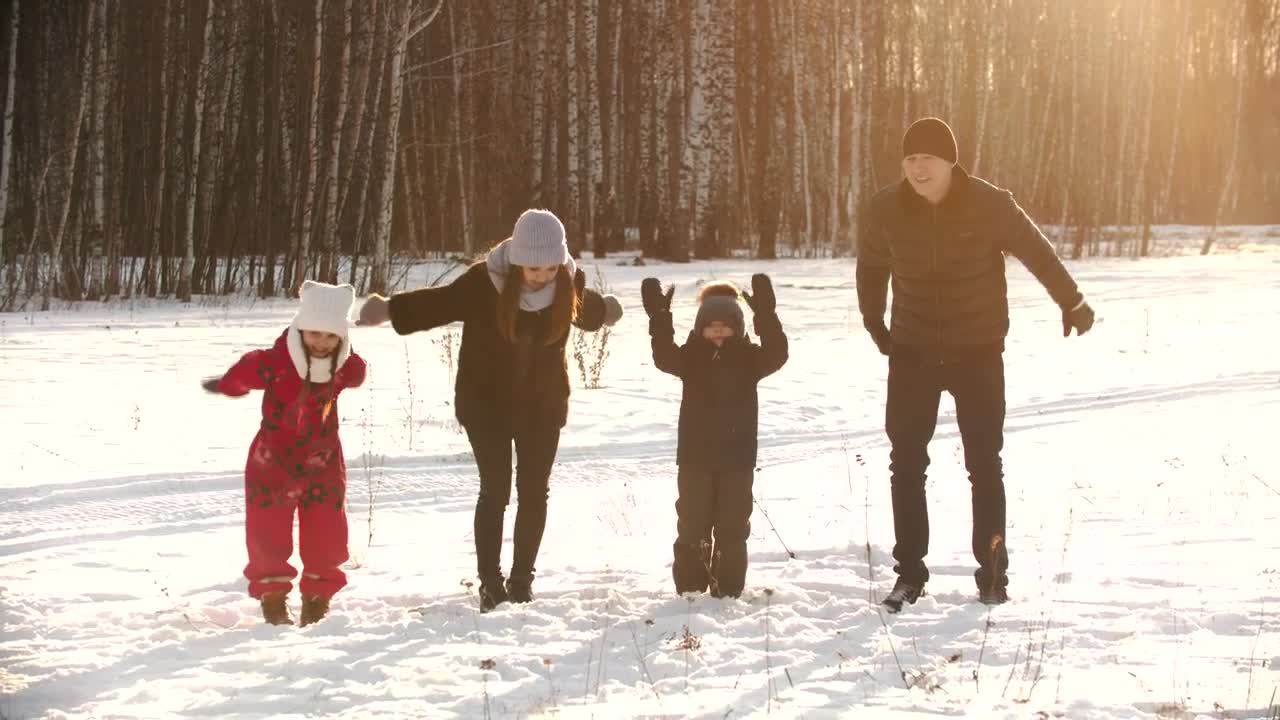 Stock Video Happy Family Jumps In The Snow In A Forest Animated Wallpaper