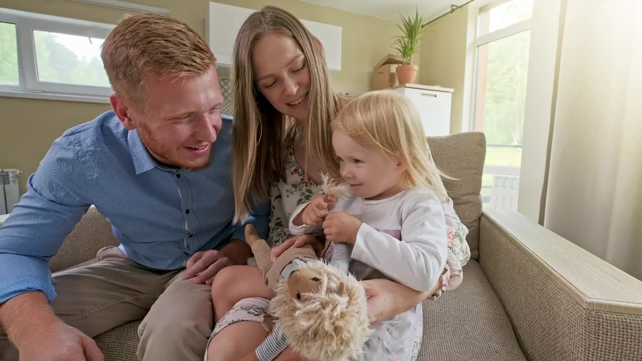 Stock Video Happy Family In An Armchair In Their New House Animated Wallpaper