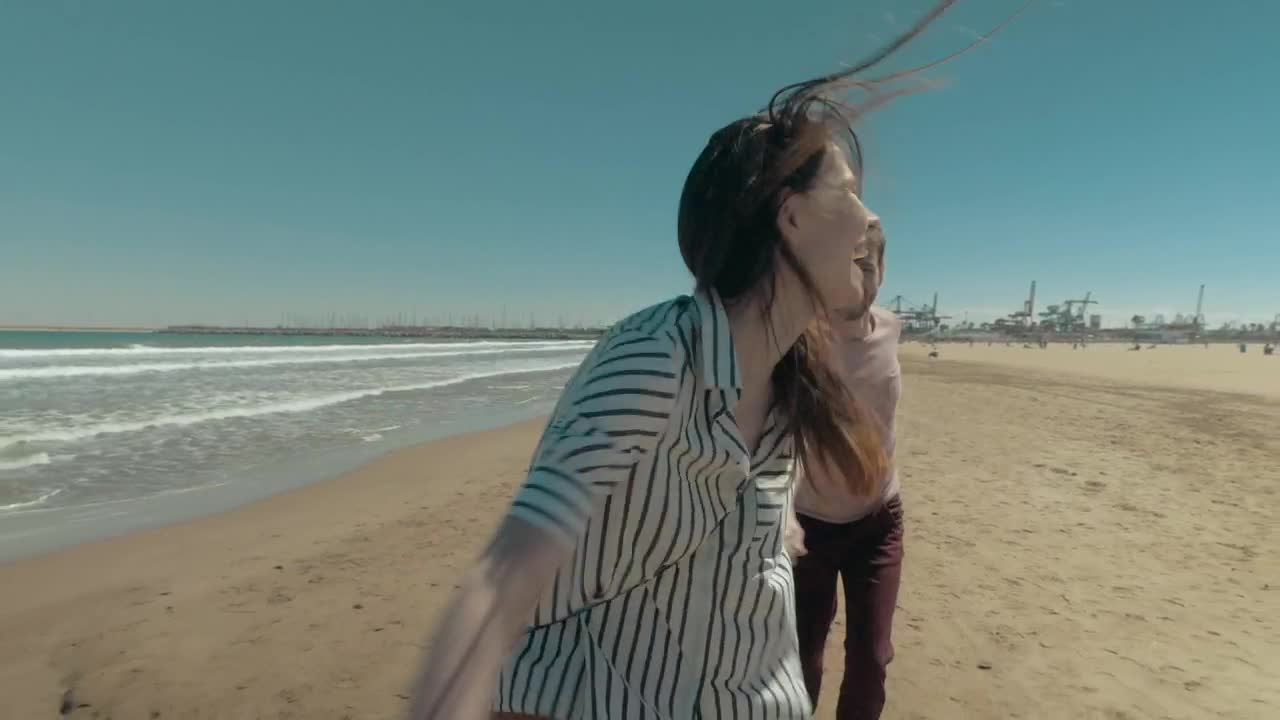 Stock Video Happy Couple Running Along The Shore Animated Wallpaper