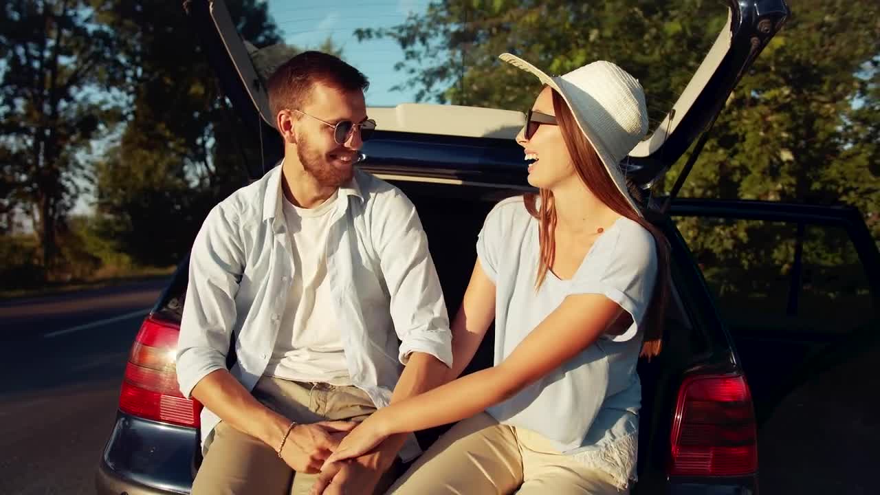 Stock Video Happy Couple Holding Hands Before Their Roadtrip Animated Wallpaper