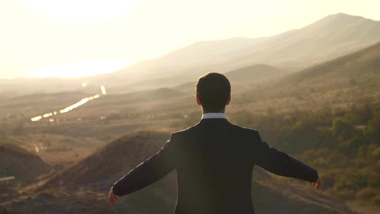 Stock Video Happy Businessman Raises Hands Seen From Behind Animated Wallpaper