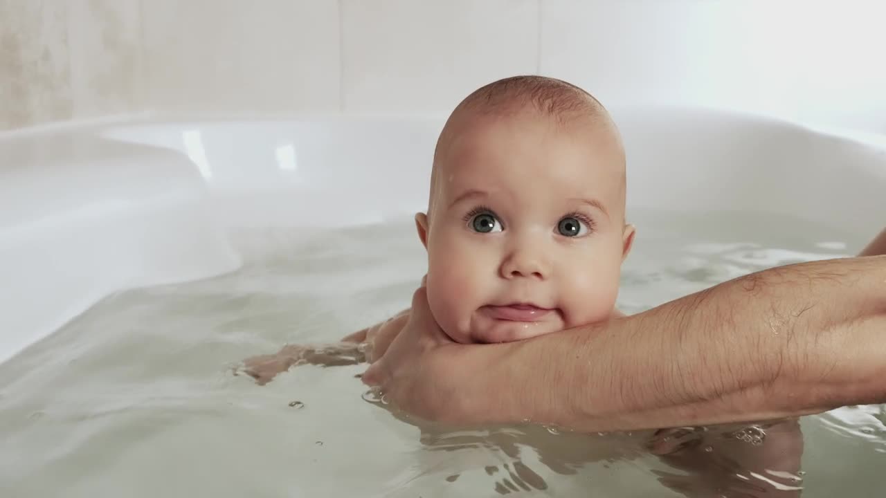 Stock Video Happy Baby Being Bathed By His Mother Animated Wallpaper