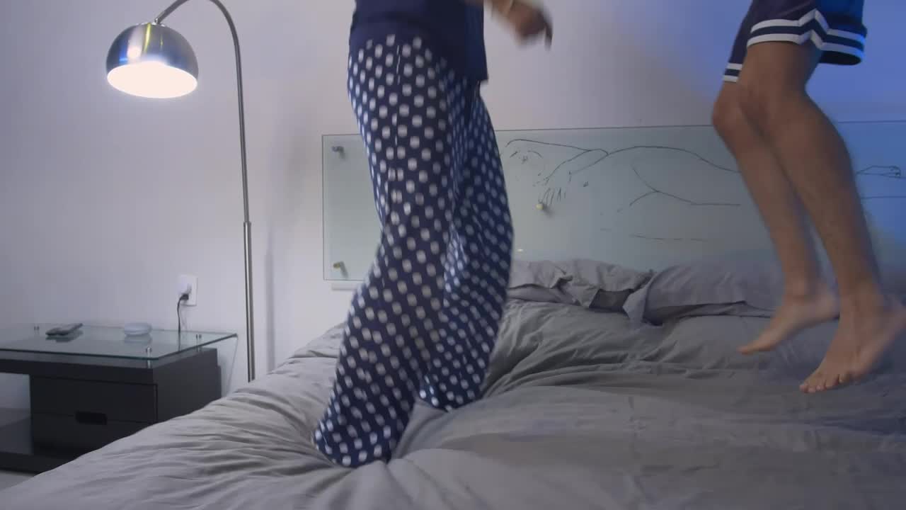 Stock Video Happily Couple Jumping On A Bed Animated Wallpaper