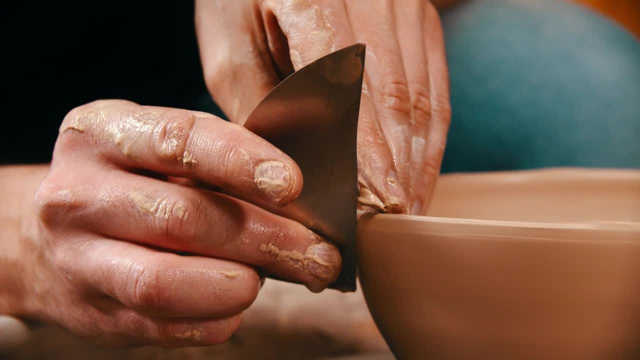 Stock Video Hans Molding A Clay Bowl With A Metal Tool Animated Wallpaper