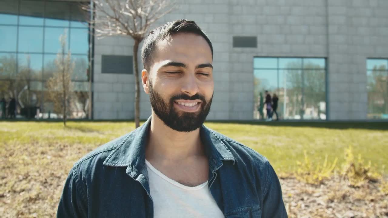 Stock Video Handsome Arab Man Smiles At Camera Outside Building Animated Wallpaper