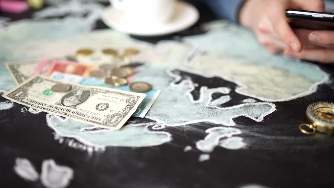 Stock Video Hands Using Mobile On Map With Money And Compass Animated Wallpaper