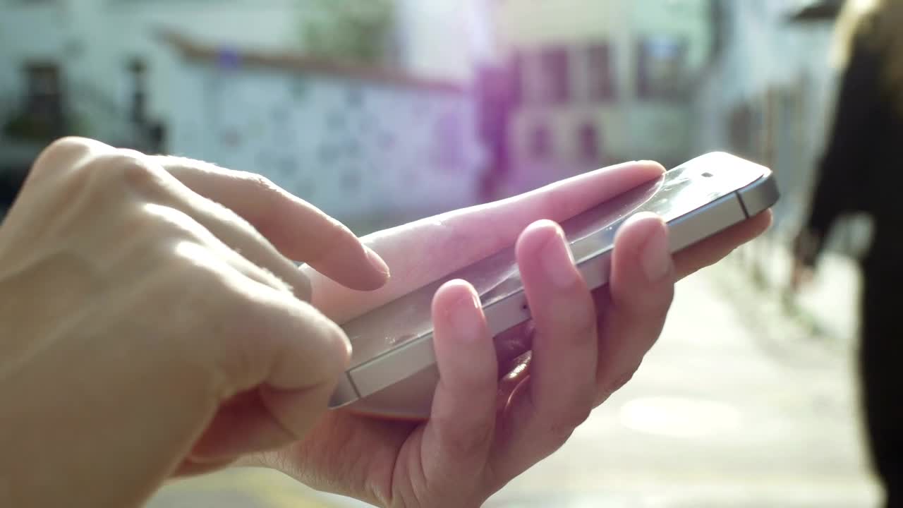 Stock Video Hands Using A Mobile Phone On The Street Animated Wallpaper
