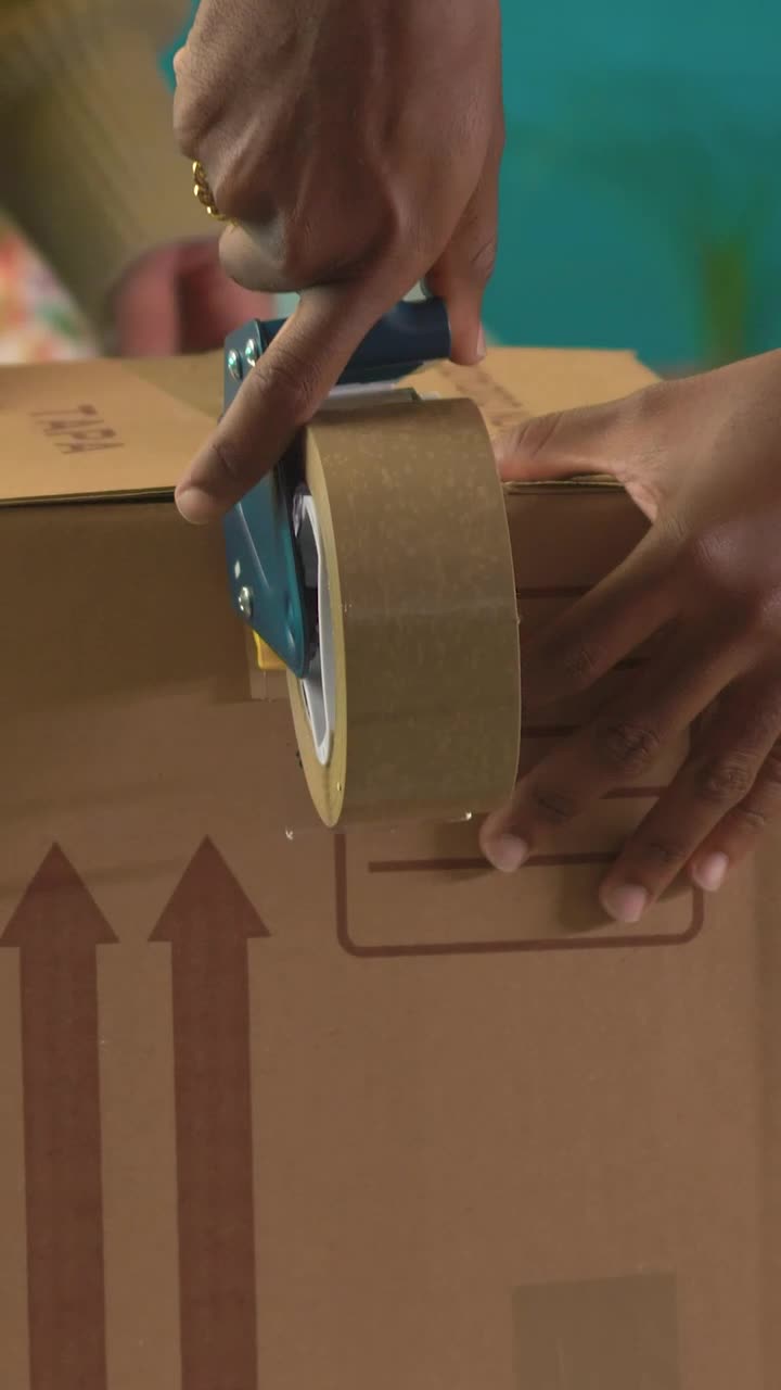 Stock Video Hands Of Two People Sealing A Package With Tape Animated Wallpaper