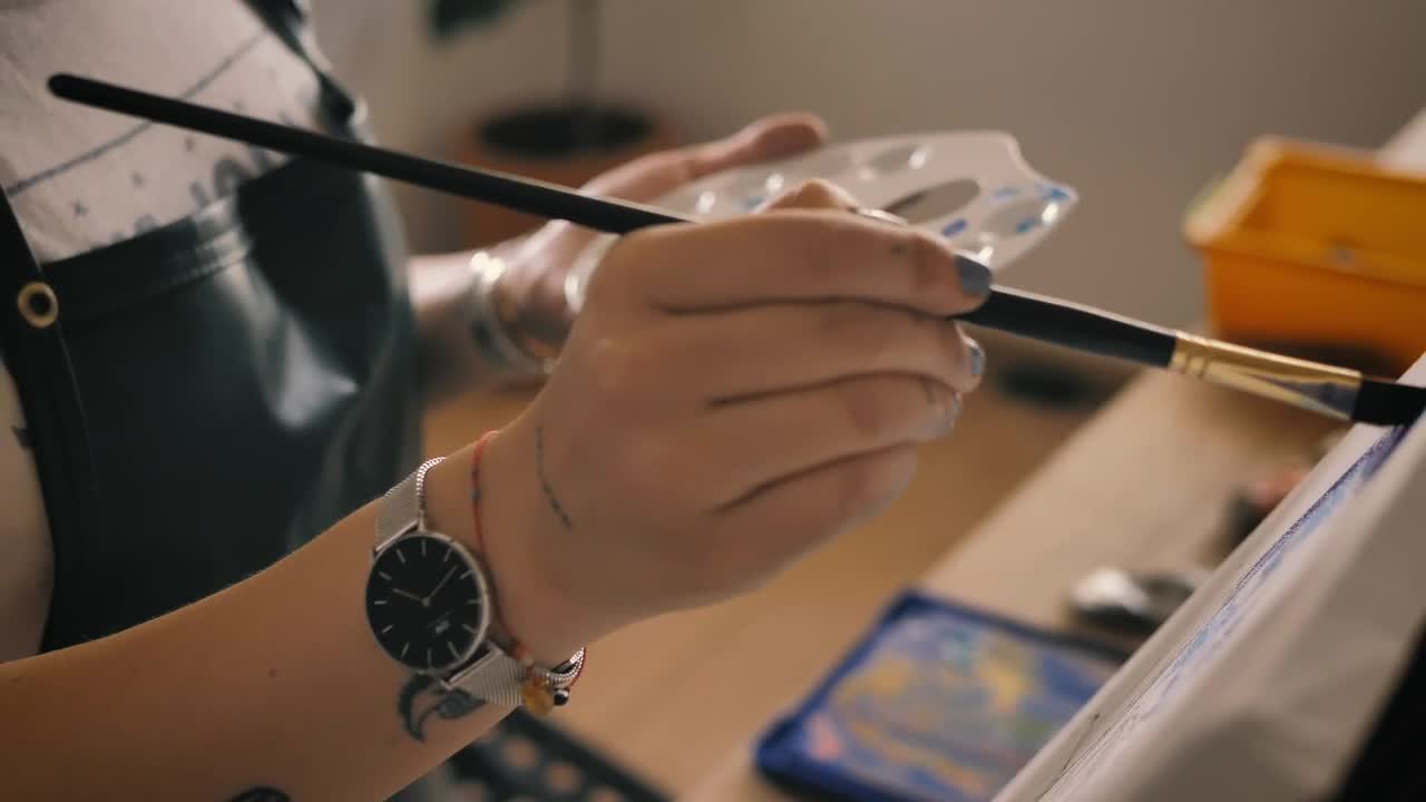Stock Video Hands Of A Young Woman Painting On A Canvas Animated Wallpaper