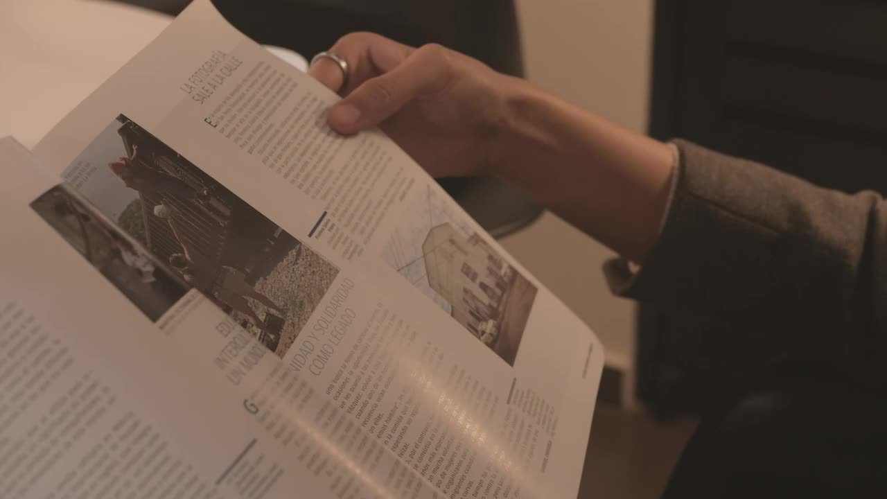 Stock Video Hands Of A Woman Slowly Leafing Through A Magazine Animated Wallpaper