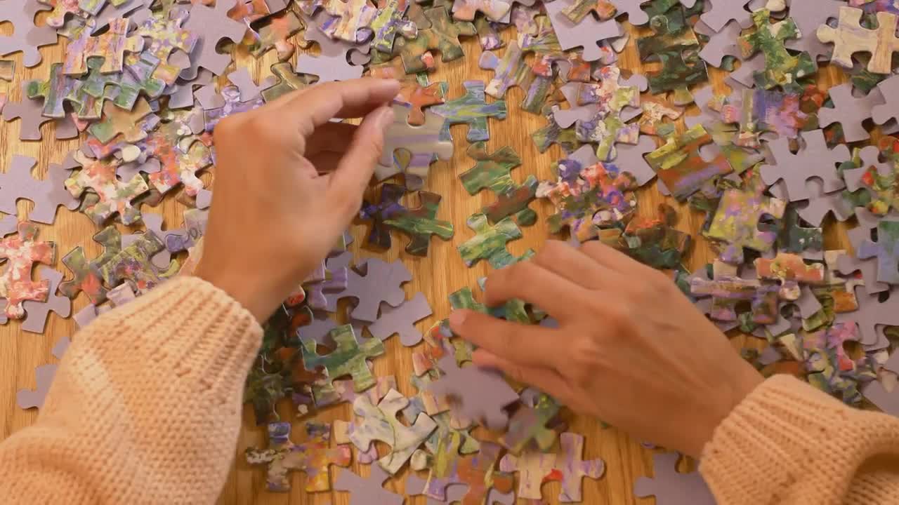 Stock Video Hands Of A Woman Playing With A Puzzle Animated Wallpaper
