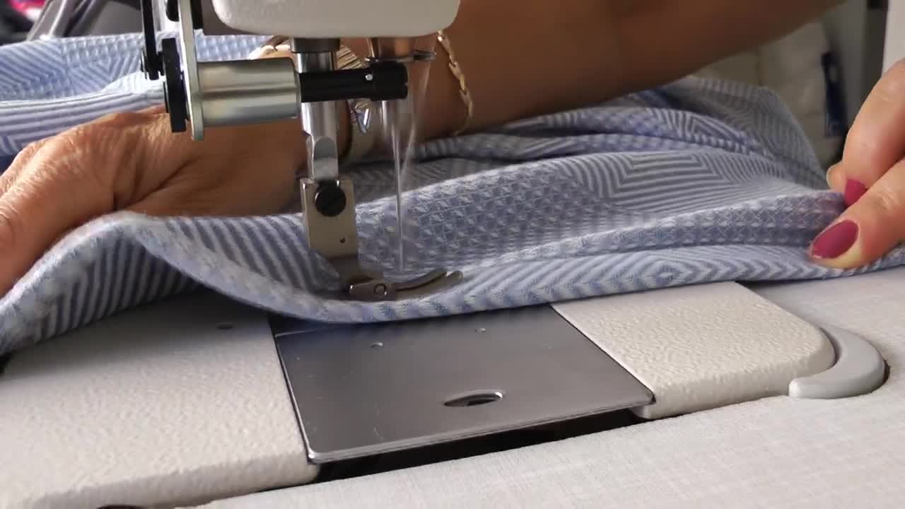 Stock Video Hands Of A Tailor Sewing A Dress Animated Wallpaper